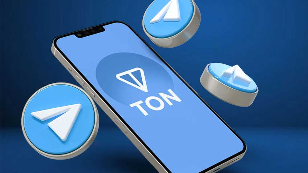 گوشی موبایل با لوگوی تون کوین و آیکونهایی از تلگرام